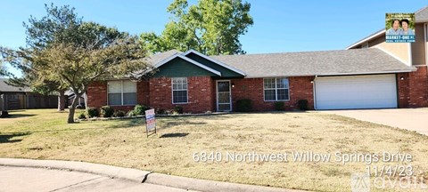 A house with a sign in front of it that says 6840 Northwest Willow Springs Drive.