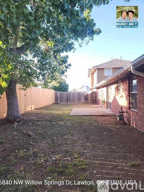 A tree is in the front yard of a house at 5840 NW Willow Springs Dr, Lawton, OK 73505, USA.