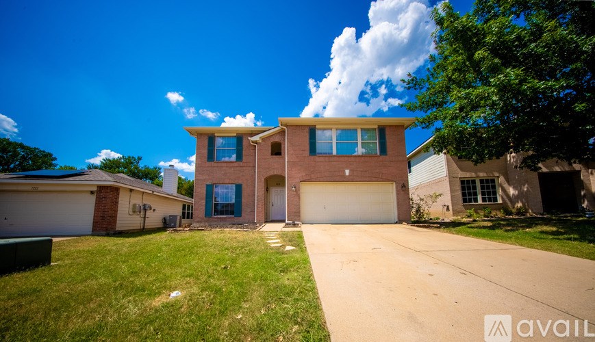 A house with a blue sky and clouds in the background.