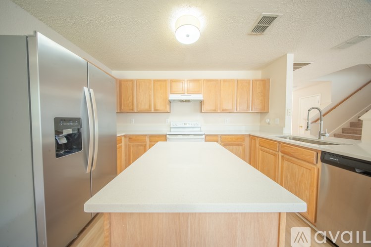 A kitchen with wooden cabinets and a white countertop.