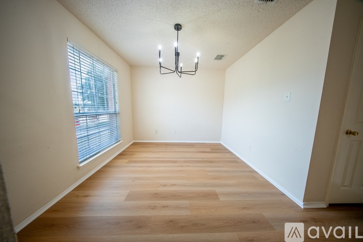 A room with wooden floors and a chandelier.