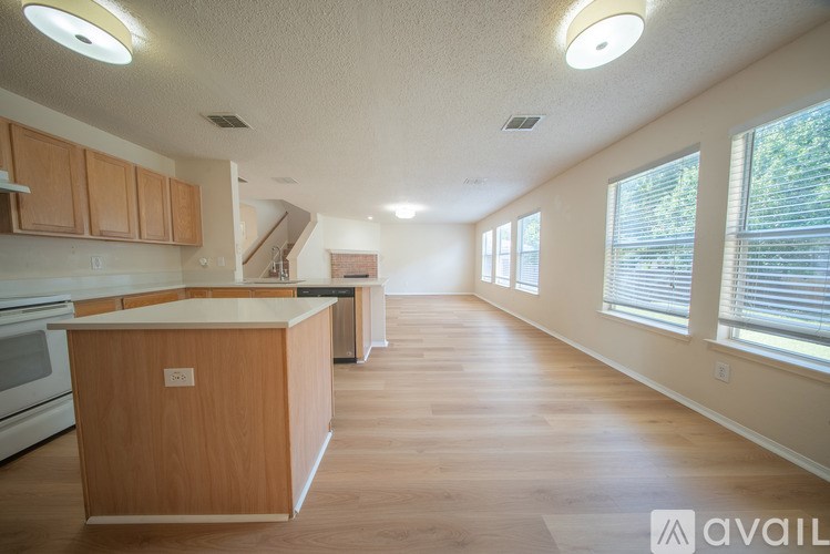 A kitchen with wooden floors and a wooden island.