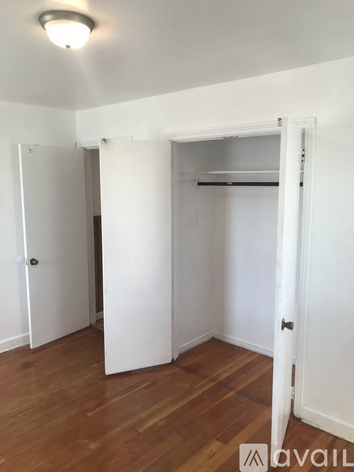 A room with a white door and a white wall.