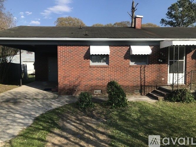 A house with a red brick exterior and a white roof.