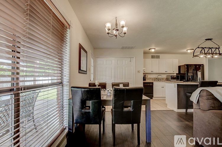 A kitchen with a dining table and chairs is available for rent.