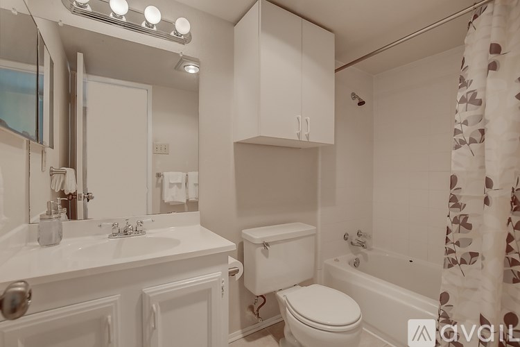 A bathroom with a white toilet, sink, and bathtub.