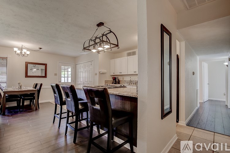 A dining room with a table set for six.