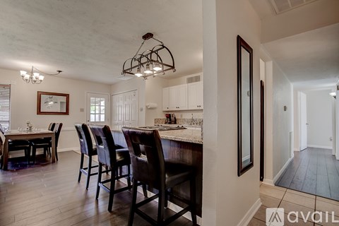 A dining room with a table set for six.