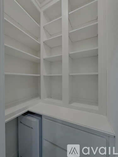 A white empty cabinet with a logo on the bottom right.