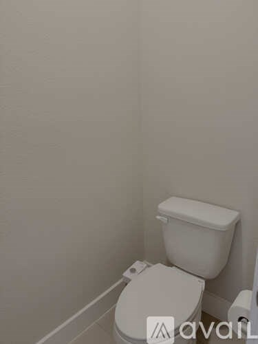 A white toilet in a small bathroom.
