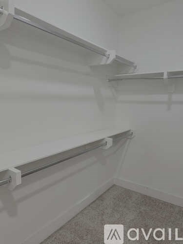 Empty shelves in a room with a carpeted floor.