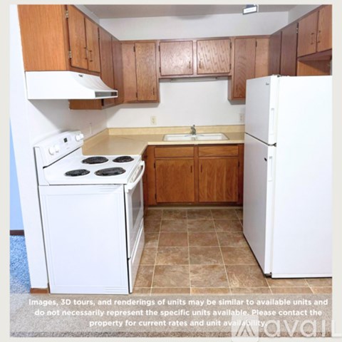 A kitchen with white appliances and wooden cabinets.