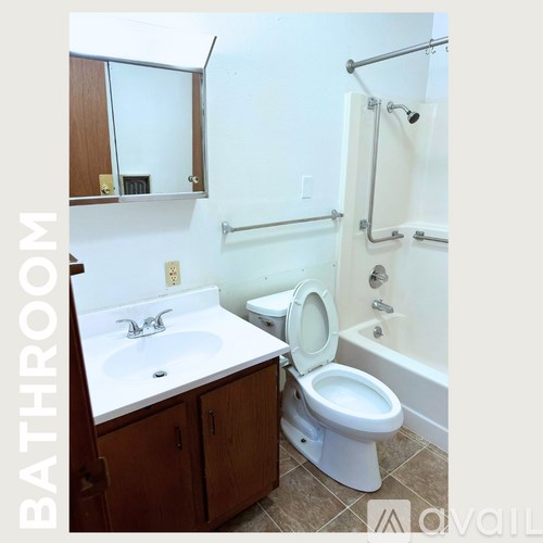 A bathroom with a toilet, sink, and bathtub.
