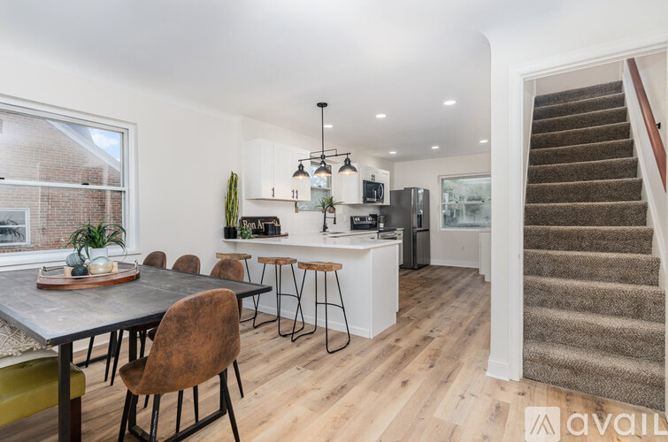 A kitchen with a dining table and chairs is available for rent.