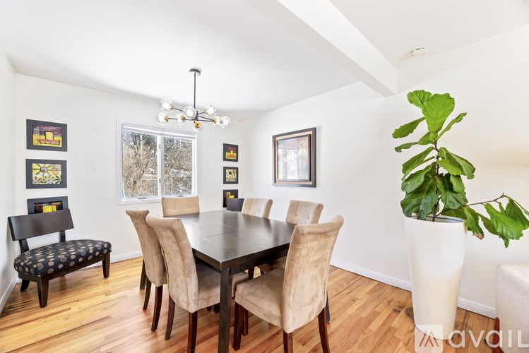 A dining room with a table and chairs.