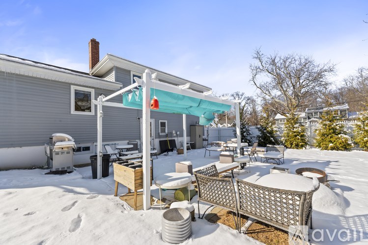 A patio with a table and chairs covered in snow.