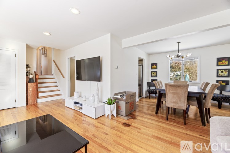 A living room with a black table and a television on the wall.