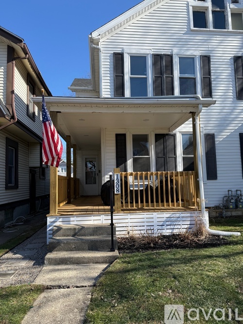 A house with a flag on the porch.