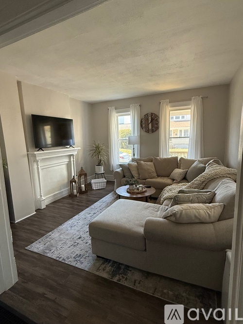 A living room with a couch, a television, and a coffee table.