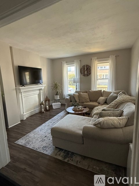 A living room with a couch, a television, and a coffee table.