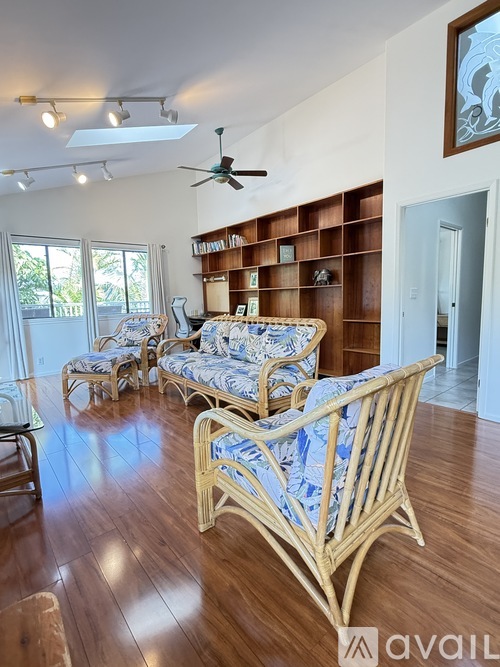 A living room with a sofa and chairs.