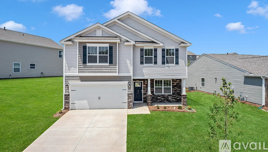 A house with a garage and a driveway is for sale.