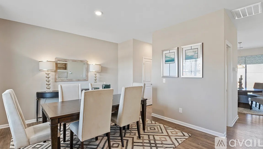 A dining room with a table set for four.