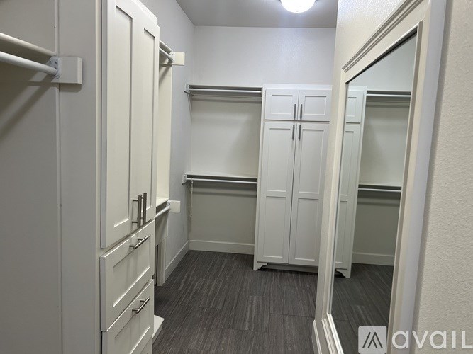 A row of white closet doors are lined up in a row.