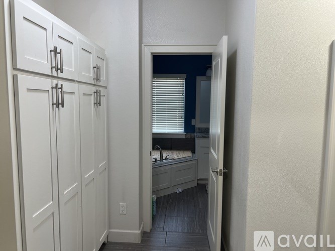 A small kitchen with white cabinets and a sink.