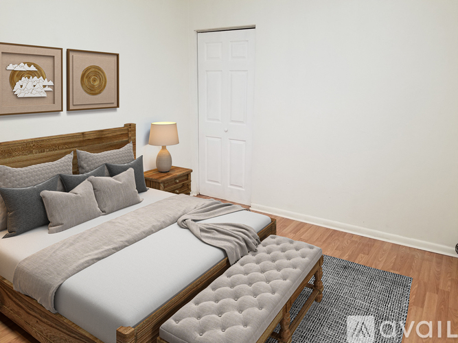 A bedroom with a large bed and a bench in front of it.