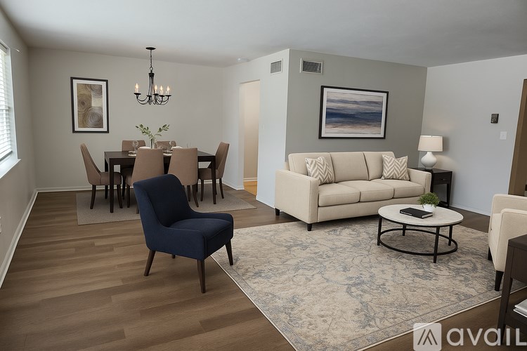 A living room with a blue chair and a beige couch.