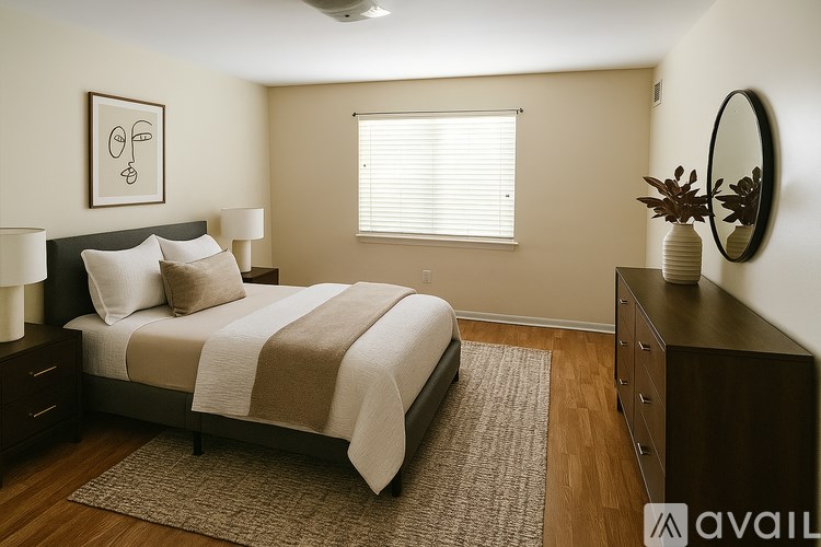 A bedroom with a bed, nightstands, and a mirror.