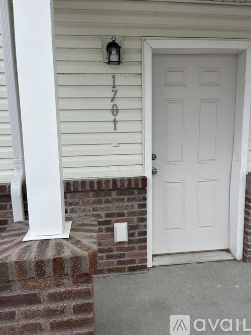 A white door with a number 1701 on the wall above it.