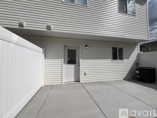 A house with a white door and a grey wall.