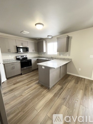 A kitchen with wooden floors and a central island.