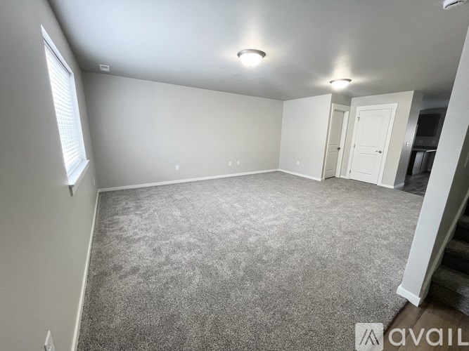 A room with carpeted floor and white walls.