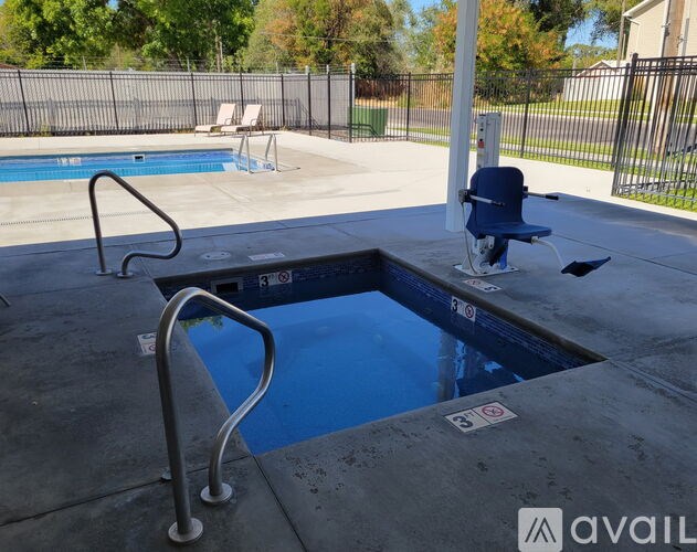 A pool with a diving board and a ladder.