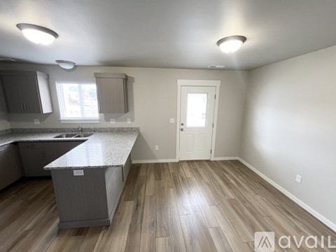 A kitchen with a countertop and cabinets is available for rent.