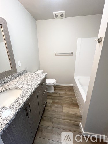 A bathroom with a toilet, sink, and tub.