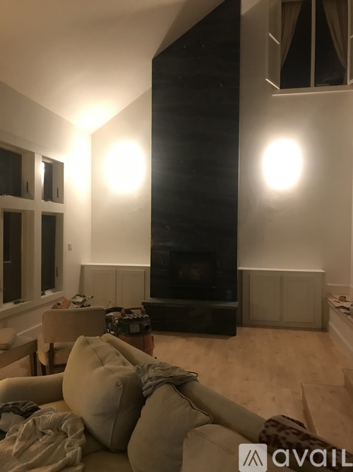 A living room with a couch and a fireplace.
