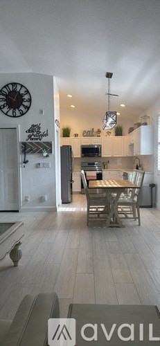 A kitchen with white cabinets and stainless steel appliances.
