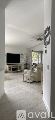 Two chairs with blue cushions are on a balcony.