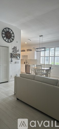A bedroom with a bed, a bench, and a ceiling fan.