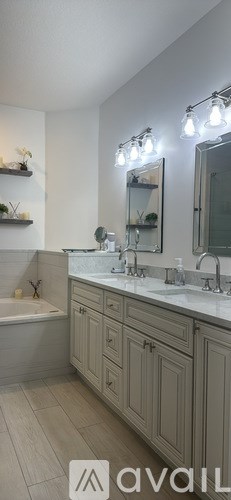 A living room with a white couch and a glass table.