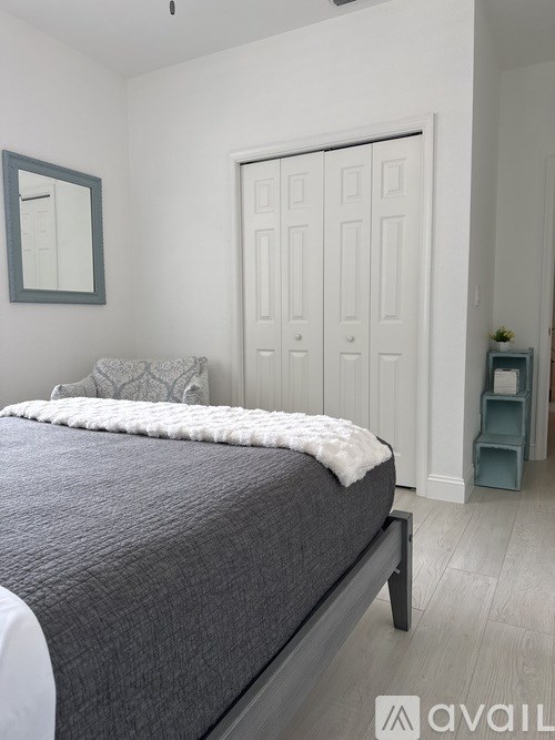 A room with a desk, chair, and a shelf with books and a sign that says FSU.