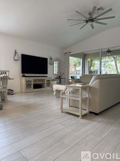A white bed with a pillow and a blanket on it.