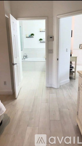 A kitchen with white cabinets and a white fridge.
