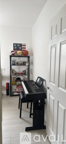 A kitchen with white cabinets and a wooden table.