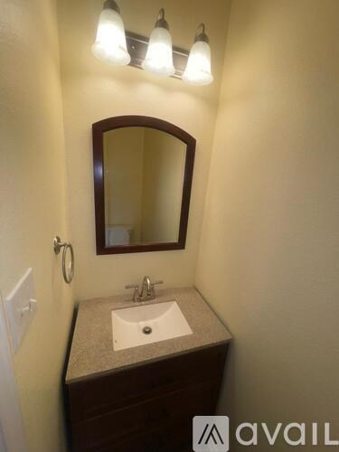 A bathroom with a sink and mirror.