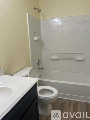 A white toilet sits next to a sink in a bathroom.